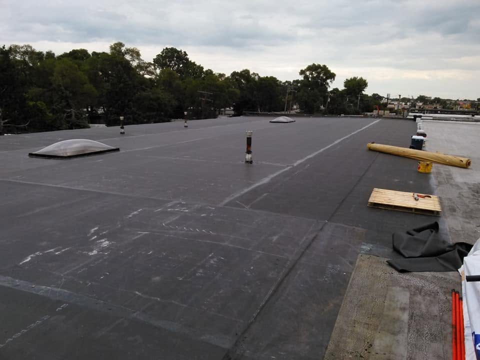 Finished black membrane flat roof on a commercial building