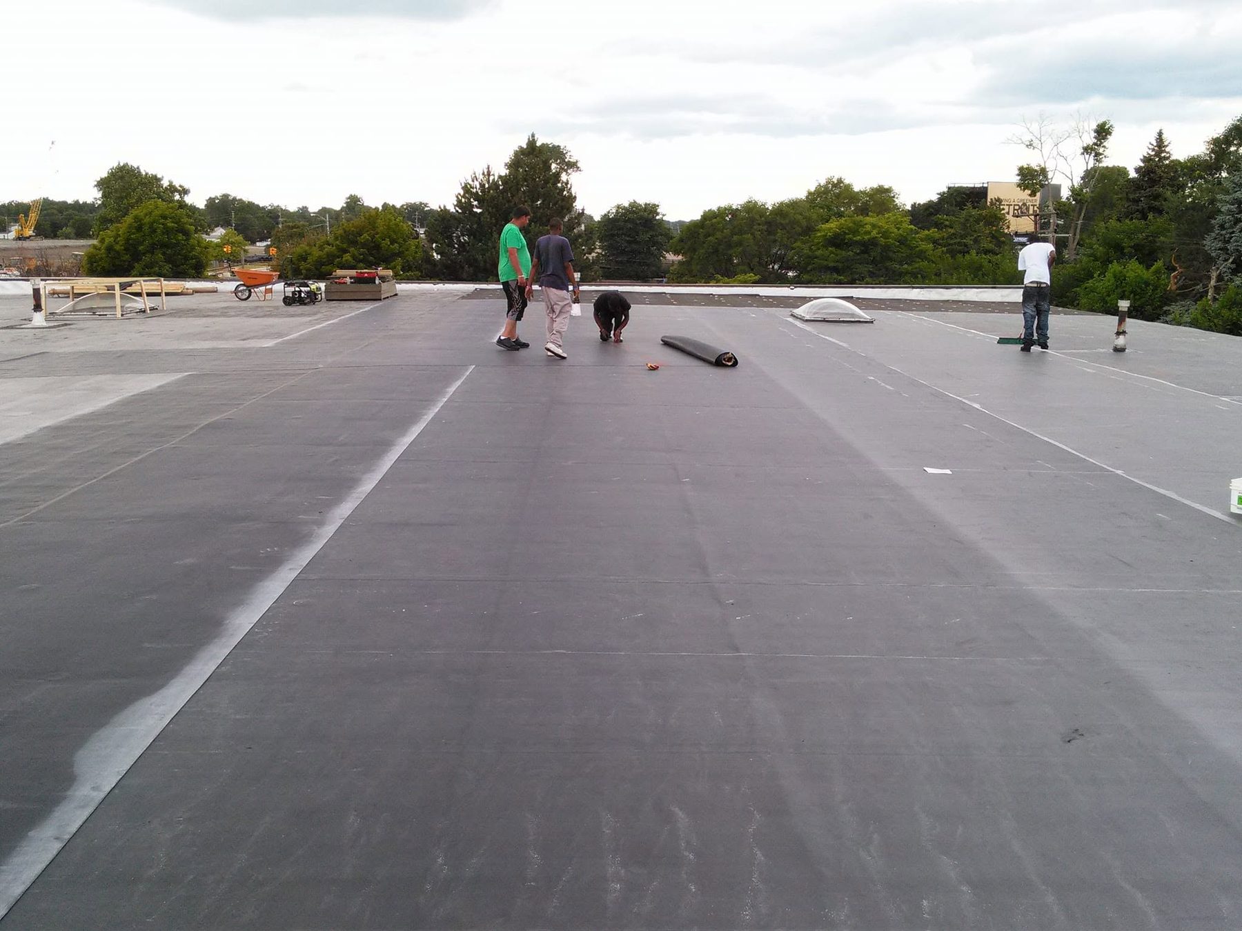 Centermark crew installing a membrane roof on a large commercial building